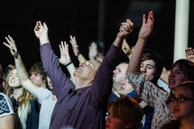 Group praising God hands lifted raised worship