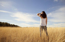 Woman in dry wheat field