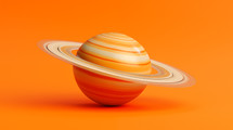 Model of Saturn planet on an orange background. 