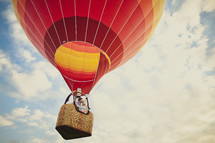 A couple kissing in a colorful hot air balloon - take you love to new heights