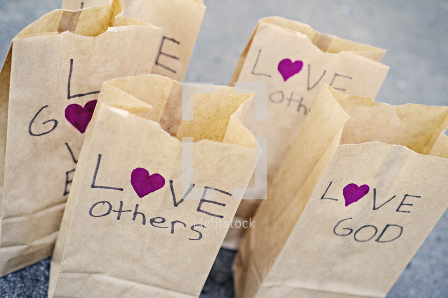 Love others, love God, paper bags