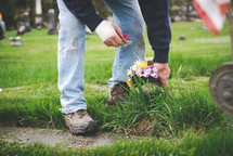laying flowers at a grave site 