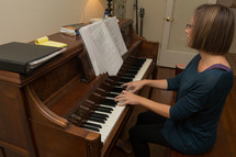 a woman playing and worshiping at a piano 