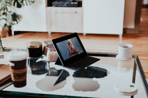 coffee cups and a laptop computer on a coffee table 