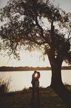 A couple embracing near a lake