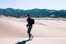 man walking barefoot in the desert 