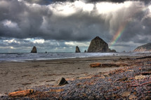 rocks and rainbow on a rocky coast