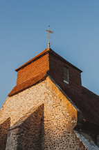 weather vane on the roof of a farm house 