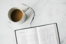 coffee cup and opened Bible 