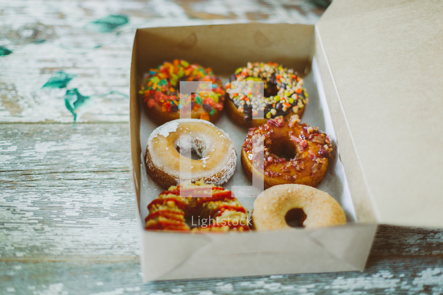 donuts with sprinkles in a box 