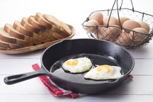 fried eggs in a skillet 