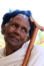 An elderly Ethiopic Orthodox woman her her prayer staff. [For Similar search Ethnic Face Smile]