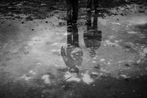 reflection of children in a puddle 