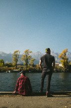 men looking out at a lake 