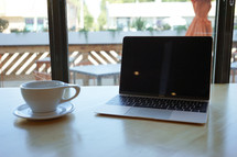 laptop computer and coffee mug