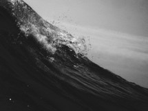 A black and white image of a wave crashing