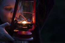 A woman holding a lantern 