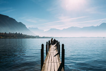 people sitting on the end of a pier in Switzerland 