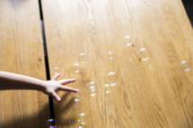 child's hand and bubbles 