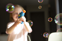 child with a bubble gun 