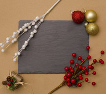 Christmas decorations around blank slate 