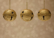 hanging gold bells against a gold background 