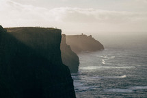 Cliffs of Moher at Sunset with Silhouettes of People on the Edge