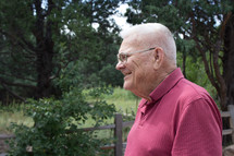 side profile of a grandfather standing outdoors 