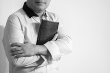 A Latino man holding a Bible 