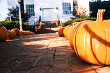 pumpkins lining the sidewalk of a church 