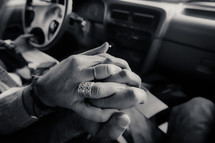 couple holding hands in a car