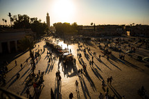 busy city square in Morocco at sunset 