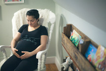 a pregnant woman holding her belly 