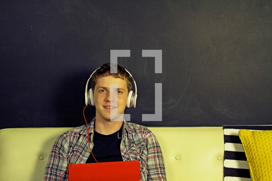 teen boy listening to music on headphones