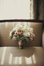 bouquet of roses resting on a couch