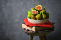 figs on a book on a stool 