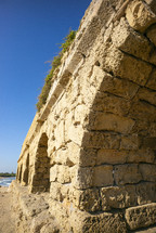 arches on a stone aqueduct outside Roman city of Caesarea
