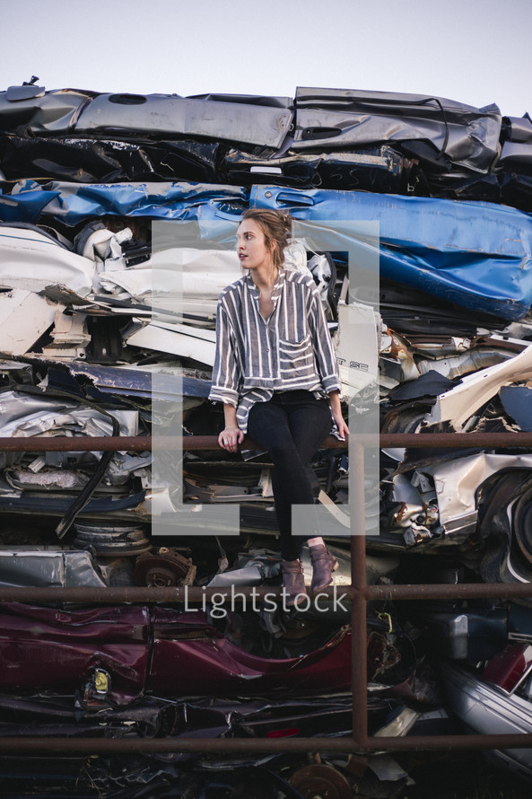 a woman in a scrap metal junk yard 