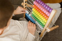 Boy Counting On An Abacus