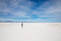 a man standing on sand dunes 