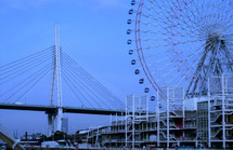 large Ferris wheel in front of a bridge in Japan