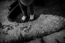 toddler feet standing in mud 