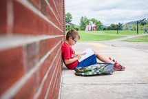 a boy sitting at school working on his homework 