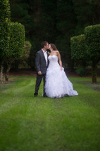 portrait of a bride and groom kissing outdoors 
