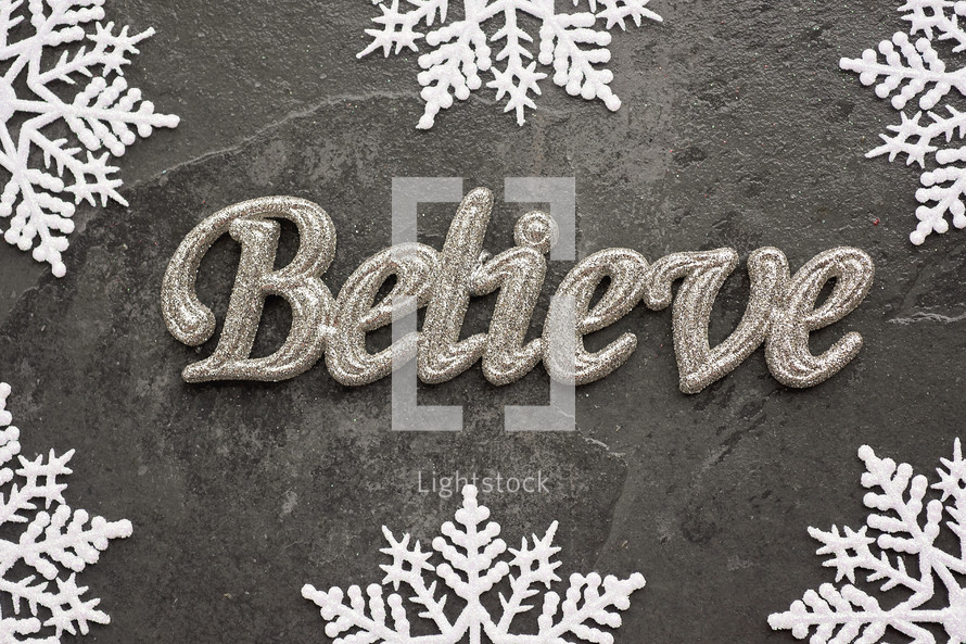 snowflake border on gray and word believe 