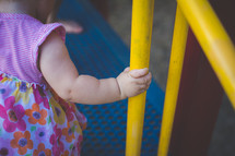 infant hand on playground equipment 