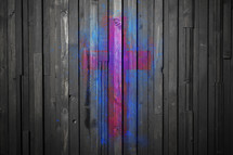 pink and blue cross painted on wood panels 
