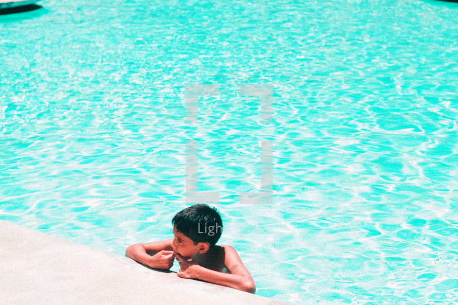 little boy at the edge of a pool 