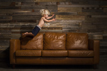 child jumping on a couch 