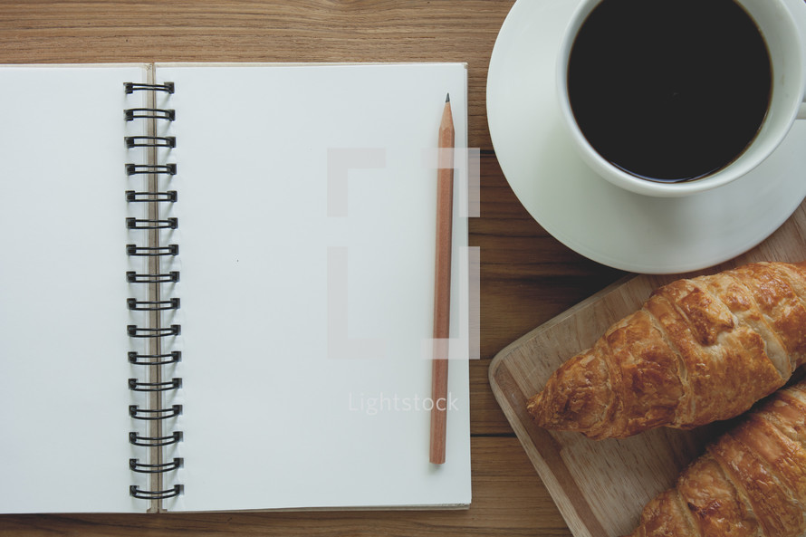 croissants, coffee, and notebook 